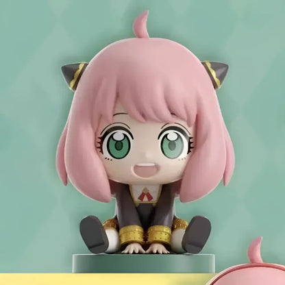 Spy x family anya sitting blind box figure with pink hair green eyes and black gold cat ears on pedestal PVC doll