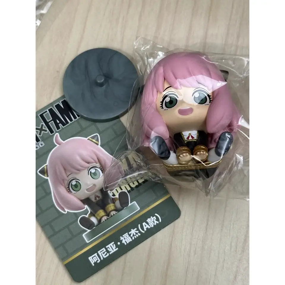 Pink-haired spy x family anya sitting blind box figure in black and gold outfit pvc desktop doll in chibi style