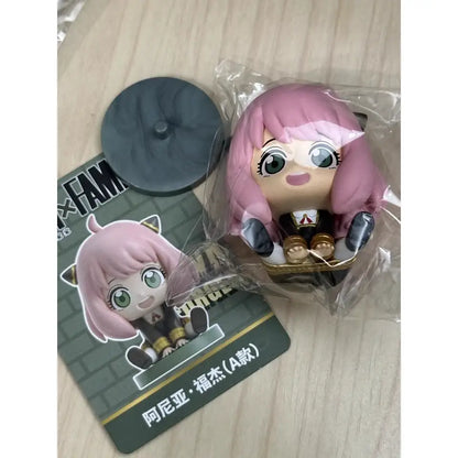 Pink-haired spy x family anya sitting blind box figure in black and gold outfit pvc desktop doll in chibi style