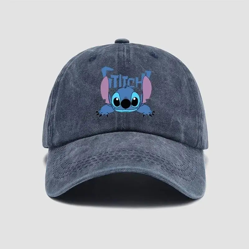 A faded dark blue denim stitch snapback cap featuring a printed cartoon stitch with pink ears and light blue eyes