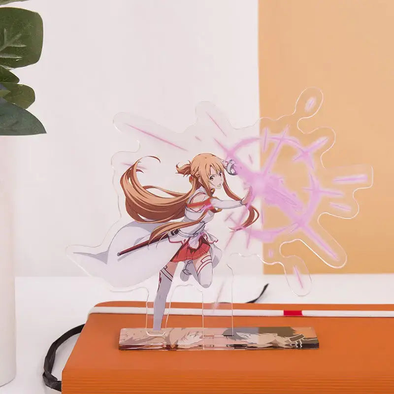 Clear acrylic stand featuring asuna from sword art online in white and red outfit mid-sword strike with pink energy effects