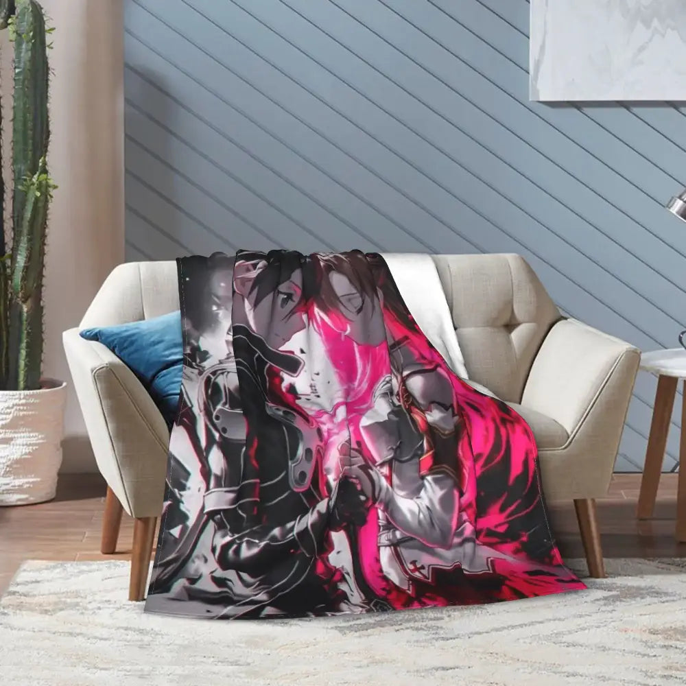 A vibrant pink and black soft fleece throw blanket featuring art online kirito asuna characters draped over a beige sofa