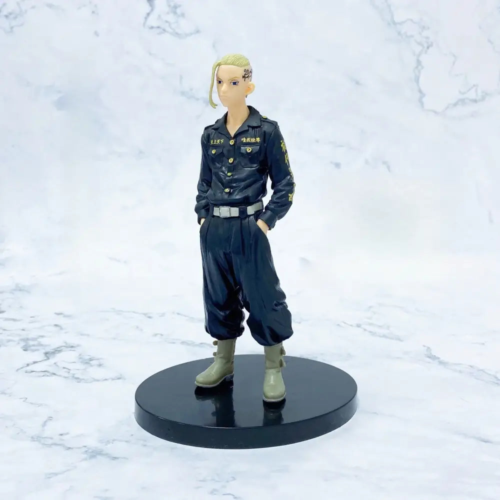 Black pvc figure of mikey from tokyo revengers with blonde hair tattoos and dark navy uniform with gold lettering