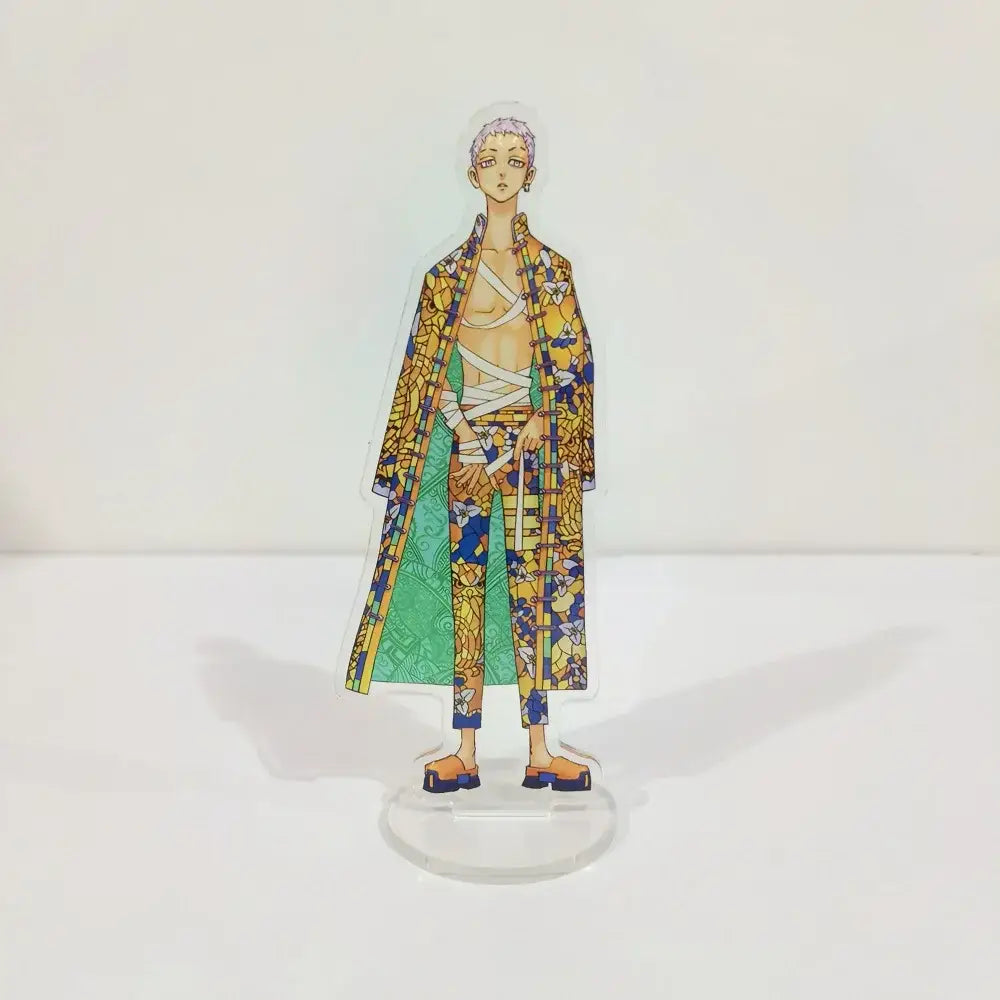 A 15cm translucent acrylic standee of ran rindo haitani from tokyo revengers wearing a yellow and blue patterned coat
