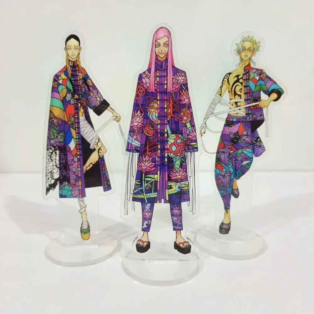 Three colorful translucent acrylic standees of ran rindo haitani from tokyo revengers with vibrant patterned outfits