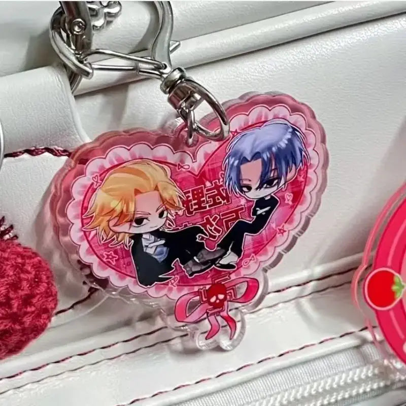 Pink heart-shaped acrylic keychain featuring two tokyo revengers anime characters in black suits with decorative lace details