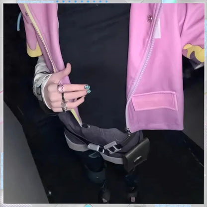 Pink bomber jacket with yellow zipper accents and subtle graphic on sleeve paired with valorant clove adjustable ring set cosplay accessory