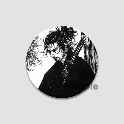 Black and white tinplate anime badge pin featuring a samurai with wild hair holding a sword from vinland saga