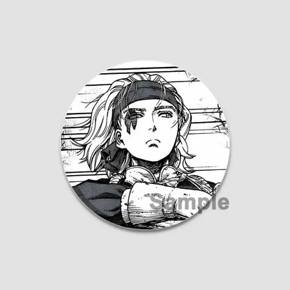 Black-and-white tinplate anime badge pin featuring vinland saga character with long hair and headband