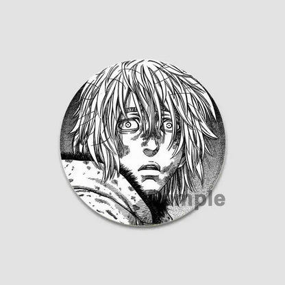 Circular black and white tinplate anime badge pin featuring detailed vinland saga character with expressive eyes and hair