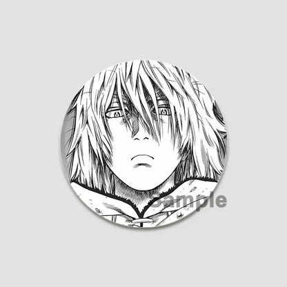 Black and white tinplate anime badge pin featuring a detailed line-art vinland saga character with intense eyes