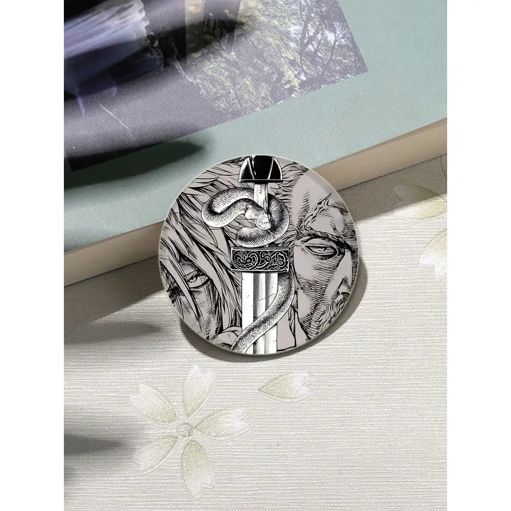 Vinland saga anime badge pin featuring a silver-toned tinplate round pin with sword and snake illustration