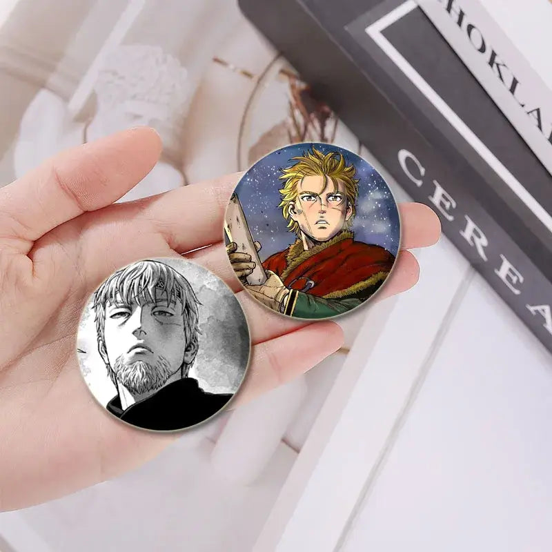 Vinland saga anime badge pin set featuring a blonde character in red and a bearded man in black-and-white tinplate plastic