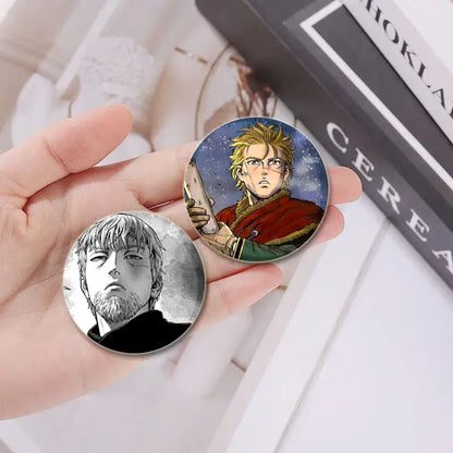 Vinland saga anime badge pin set featuring a blonde character in red and a bearded man in black-and-white tinplate plastic