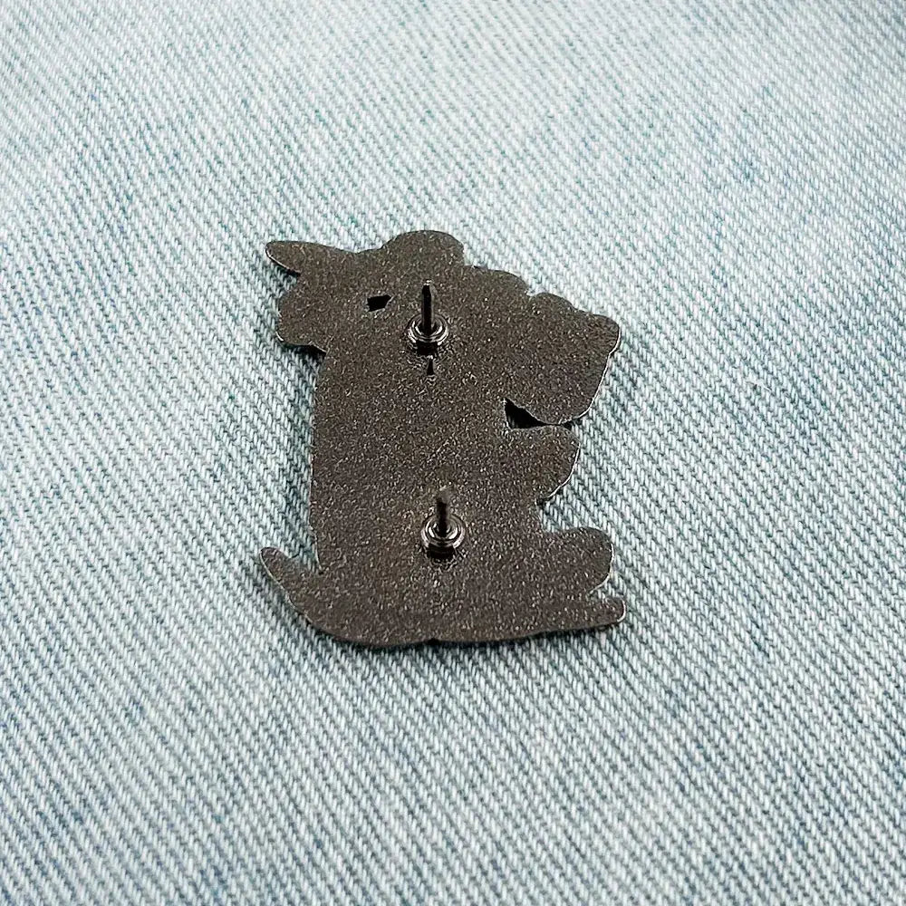 Dark gray metal askeladd lapel pin shaped like a koala with two silver-toned fasteners back side shown