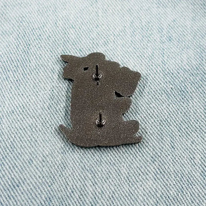 Dark gray metal askeladd lapel pin shaped like a koala with two silver-toned fasteners back side shown