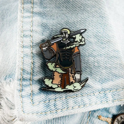 Vinland saga askeladd lapel pin enamel badge featuring a warrior with blonde hair in black and orange armor on clouds