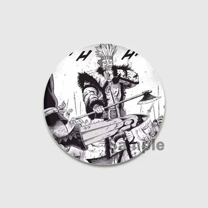 Circular black-and-white vinland saga badge pin featuring a spiky-haired warrior with fur-lined armor holding an axe