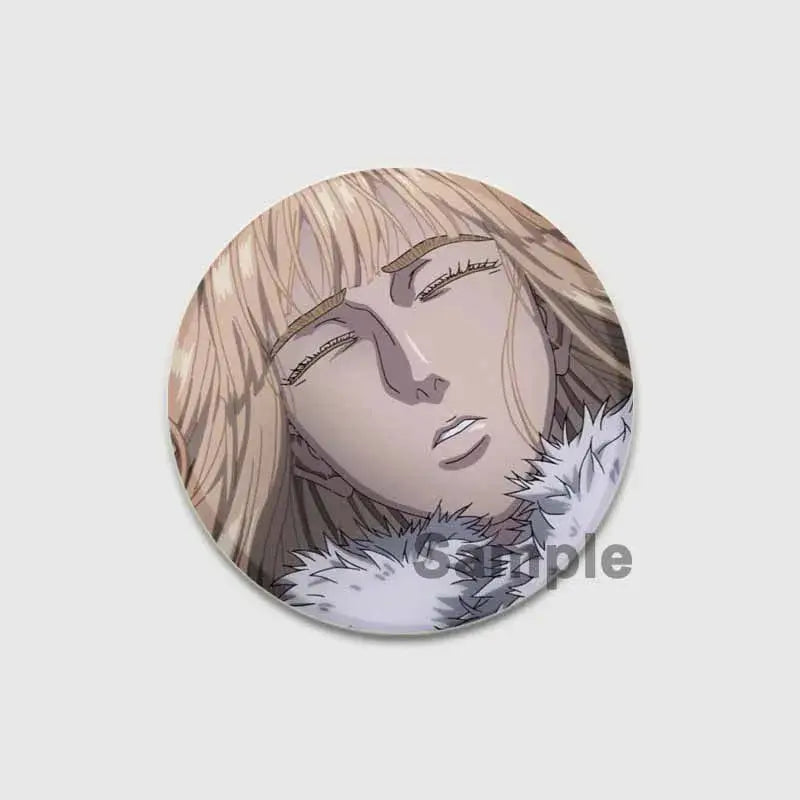 Circular vinland saga badge pin featuring an anime character with long blonde hair and white fur collar on tinplate