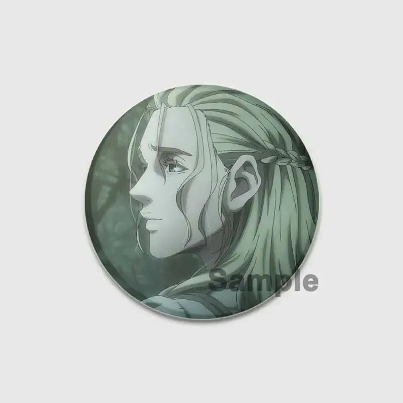 Circular vinland saga badge pin featuring an anime style portrait with long braided green hair on a handmade tinplate brooch