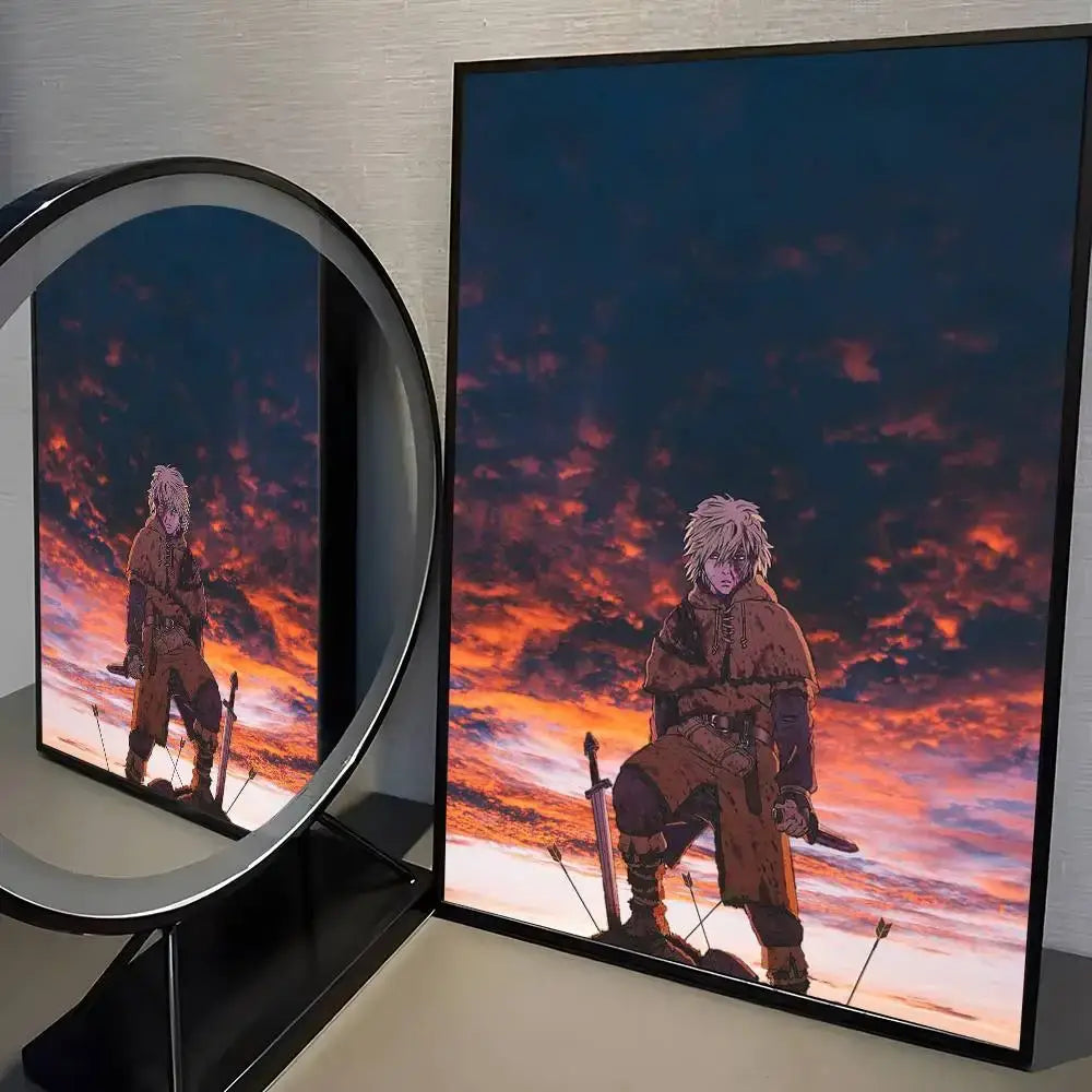 Black-framed vinland saga manga wall art featuring white-haired character in rugged brown attire against orange blue sky
