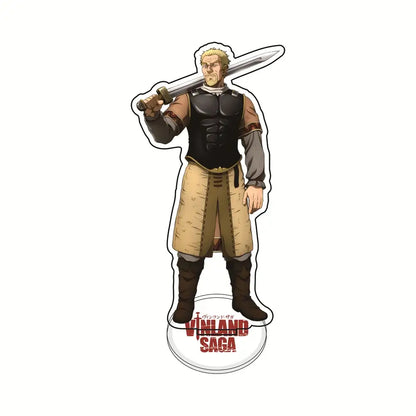 A clear acrylic vinland saga thorfinn acrylic stand featuring a muscular blonde warrior in black armor holding a sword