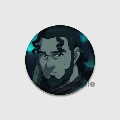 Circular vinland saga thorfinn button brooch with a bearded man illustration on teal and black tinplate soft badge