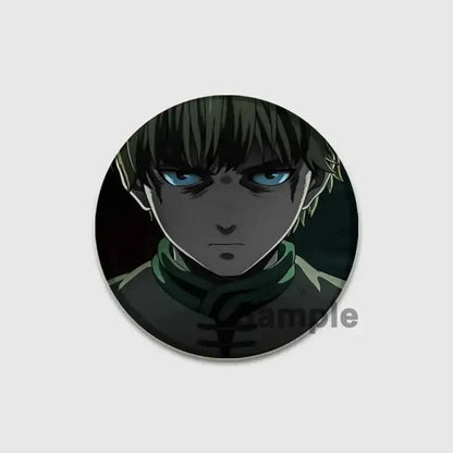 Circular tinplate vinland saga thorfinn button brooch with intense blue eyes and dark green hair scarf design