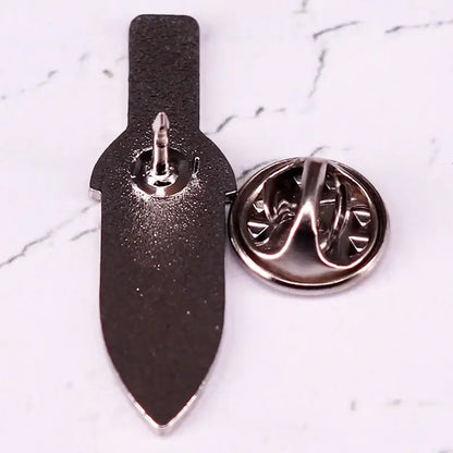 Black hard enamel vinland saga thorfinn dagger enamel pin with silver toned metal clasp and backing shown from back side