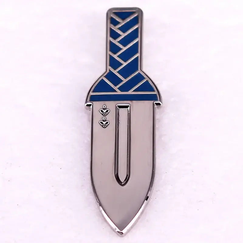 Silver hard enamel pin shaped like a vinland saga thorfinn dagger with blue braided hilt and heart motifs on blade