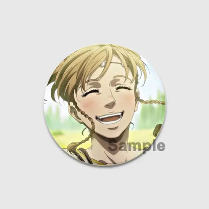 Circular vinland saga thorfinn enamel pin with smiling blonde braided character on green and yellow background, handmade