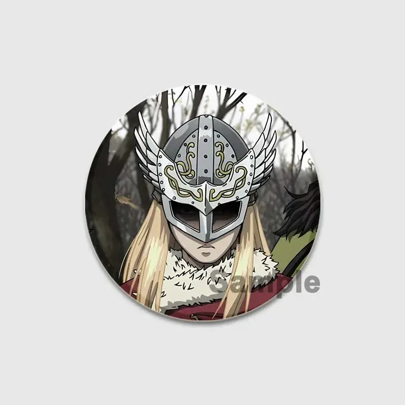 Circular vinland saga thorfinn enamel pin featuring silver winged helmet with gold tribal patterns and white fur trim