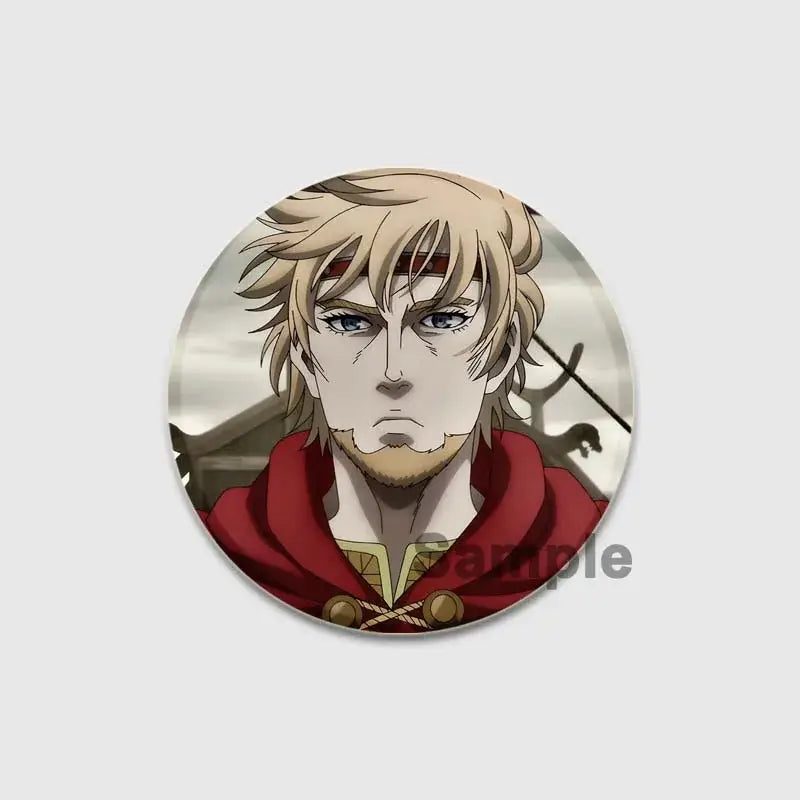 Circular handmade vinland saga thorfinn enamel pin featuring an anime character with blonde hair and red hooded cloak
