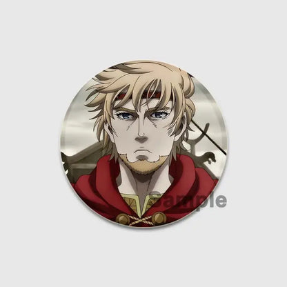 Circular handmade vinland saga thorfinn enamel pin featuring an anime character with blonde hair and red hooded cloak
