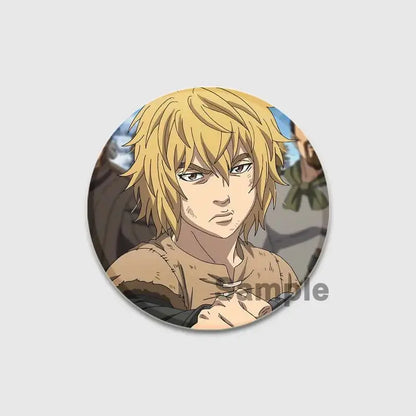 Circular vinland saga thorfinn enamel pin featuring spiky blonde anime character in rugged earth-toned outfit handcrafted