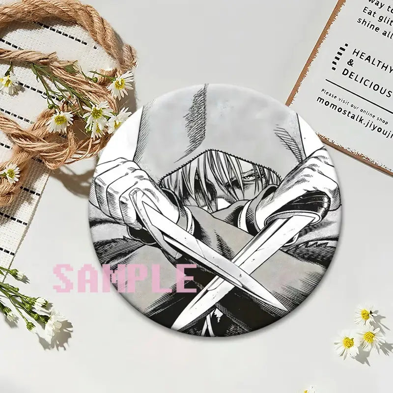 Circular black-and-white vinland saga thorfinn lapel pin featuring the character gripping two crossed swords