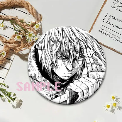 Black-and-white illustrated round vinyl lapel pin featuring vinland saga thorfinn with spiky hair and intense expression