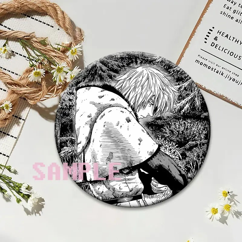 Black and white circular vinland saga thorfinn lapel pin featuring detailed line art of light-haired figure