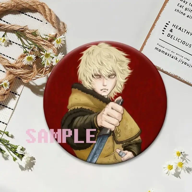 Red circular vinland saga thorfinn lapel pin featuring anime character with blonde hair and yellow coat holding sword