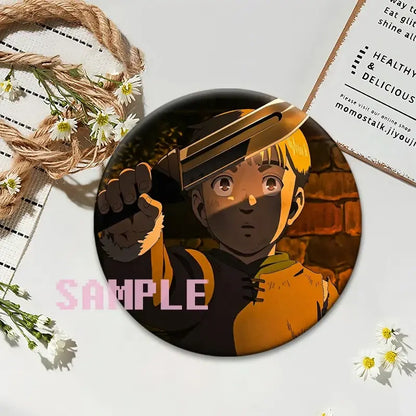 Circular black vinland saga thorfinn lapel pin featuring an anime character with blonde hair and orange clothing