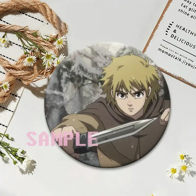 Vinland saga thorfinn lapel pin featuring a blonde-haired figure in brown robes holding a silver sword in snowy forest background