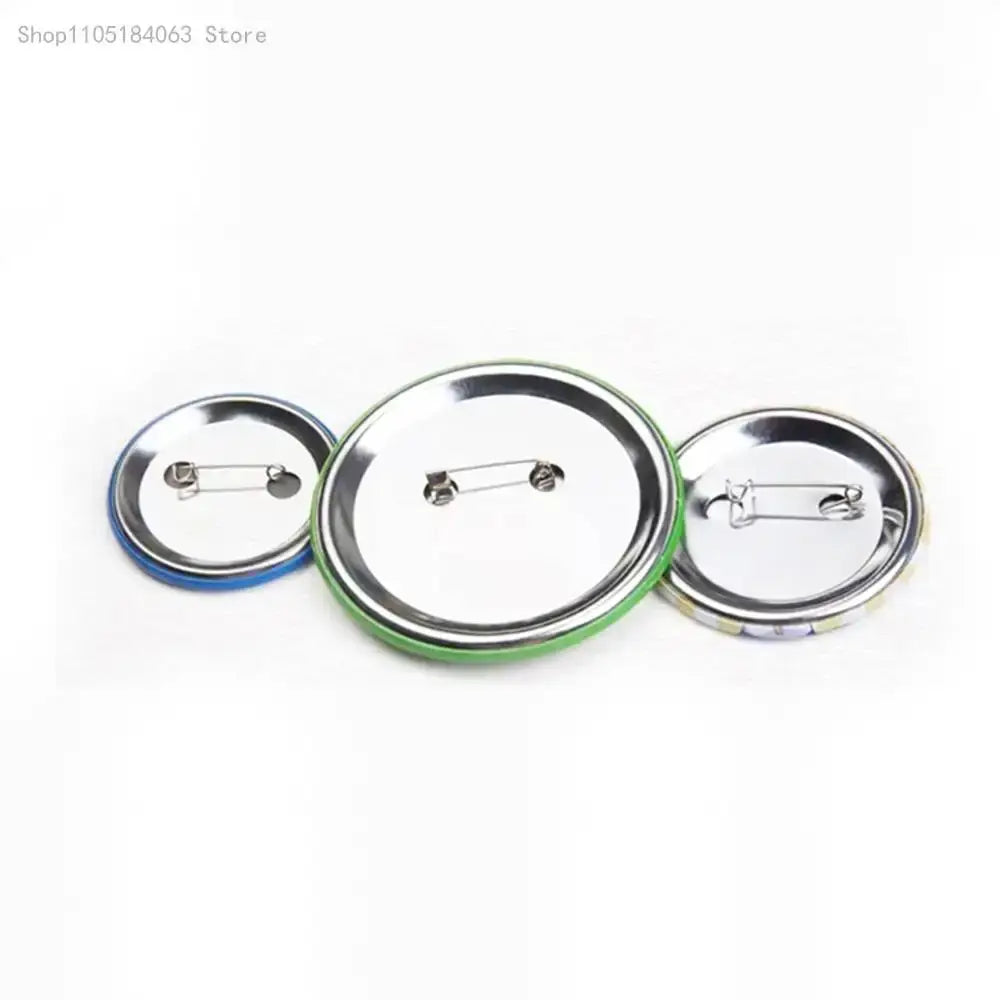 Three round thorfinn pin badges with colorful plastic rims and metallic silver backs in blue green and multicolored designs
