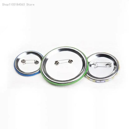 Three round thorfinn pin badges with colorful plastic rims and metallic silver backs in blue green and multicolored designs