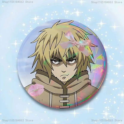 Circular holographic thorfinn pin badge featuring an anime character with spiky blonde hair and beige hooded outfit