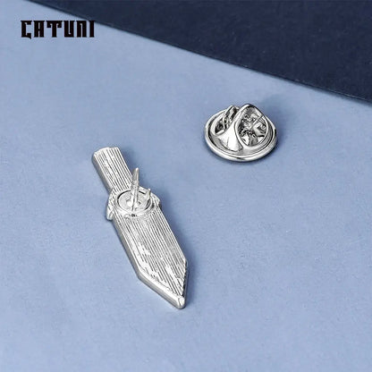 Silver metallic vinland saga thorfinn pin brooch shaped like stylized sword with engraved vertical lines on blade
