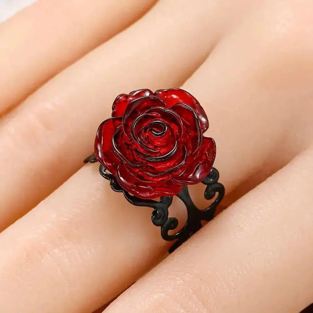 Vibrant red rose vine ring with a translucent rose-shaped centerpiece and intricate black vine metal band for gothic style